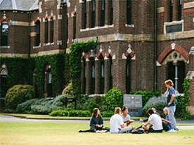 Students enjoying the picturesque °Ŀ grounds in front of the most historic building
